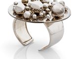 a close up of a silver ring on a white surface
