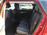 the back seats of a red car with black seats in the back