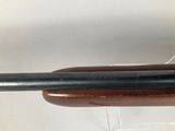 a close up of a rifle on display in a glass case