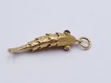 an image of a gold charm with a bird on it ' s back