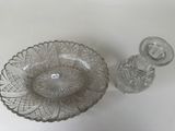 a glass bowl and a glass bottle sitting on a table