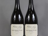 two bottles of wine sitting on top of a table