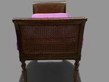 an image of a wicker chair with a pink cushion on it