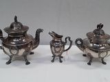 pair of antique silver plated teapots and saucers