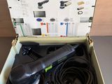 an open box with a corded sander and a corded sander in it