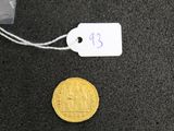 a gold coin with a price tag attached to it