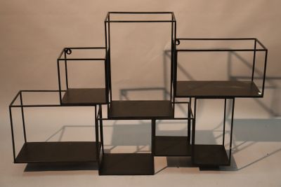 three black metal shelves are stacked on top of each other