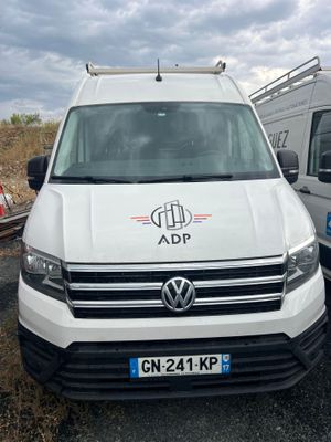 two vans parked next to each other on the side of the road