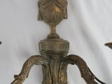 pair of antique brass wall sconces on a white background