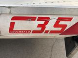 a close up of a red and white logo on a truck
