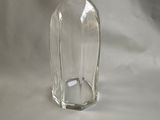 a clear glass bottle with a glass stopper on top of it