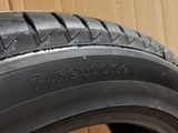 the tire of a car is sitting on the floor next to a cardboard box