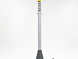 a lamp with a yellow cone on top of it next to a black pole