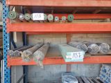 many rolls of fabric on the shelves in the warehouse