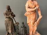 two statues of a woman and a man standing next to each other