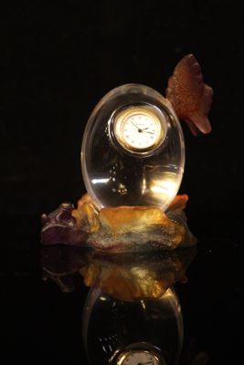 a glass ball with a clock inside of it on a table