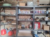 a room with a lot of shelves and boxes on it