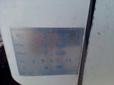 a close up of a clock on the side of a refrigerator