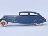 a blue toy car that is sitting on a white surface