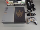 a video game console with a controller and a charger
