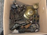 a cardboard box filled with assorted metal items