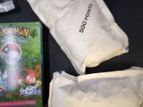 a box of pokemon cards and a bag of candy on a table