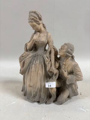 deux figurines représentant une femme et un garçon assis sur un banc