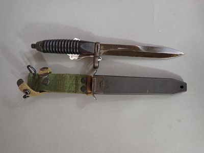 two knives that are laying next to each other on a table