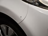 a close up of a car ' s headlight and the front end of the car