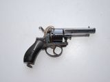 an old revolver is laying on a white surface
