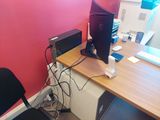 a desk with a computer monitor and a laptop on it