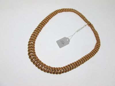 an image of a gold necklace with a tag attached to it