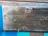a close up of a metal sign on a blue machine