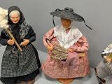 five figurines of people sitting next to each other