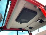 a red truck with a speaker in the back of it ' s cab