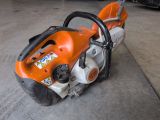 a chainsaw sitting on the ground in a garage