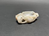 a small white object on a table with a black background