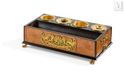a wooden box that has a gold plate on it