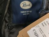 a tag on a jacket that is being held by a person