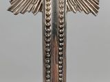 a close up of a silver cross with a red cross on it