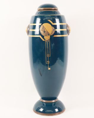 a large blue vase with a gold decoration on it