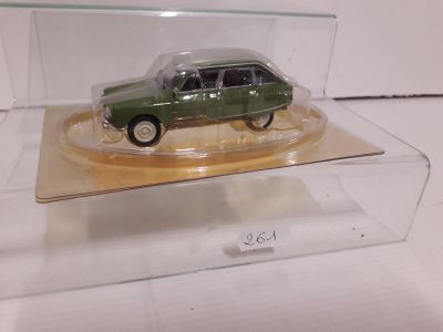 a green toy car in a clear box on a table