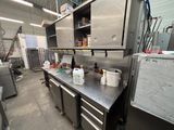 a kitchen with a lot of appliances in it