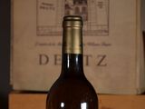 a bottle of wine sitting on a table next to a box