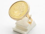 an image of a gold ring with a coin on top of it