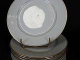 several white plates stacked on top of each other on a black surface