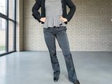 a woman that is standing in a room with her hands on her hips