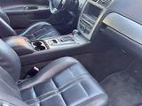 the interior of a car with black leather seats and steering controls