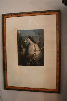 a framed picture of a man with a sword in a room