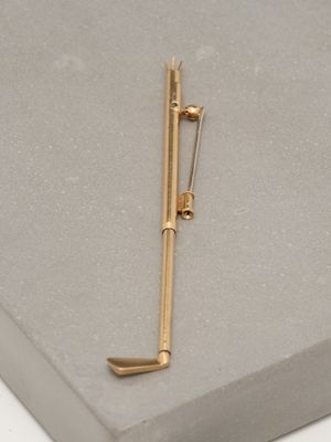 a gold pen and a pair of scissors on a table